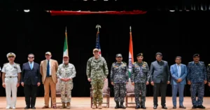 Multinational naval officers during command ceremony linked to Combined Task Force 154