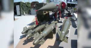 HAMMER missile production system displayed under fighter aircraft at defence exhibition