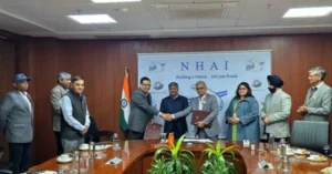 IHMCL and NFSU officials exchange MoU documents during signing ceremony at NHAI