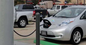 Electric four-wheelers charging at a public EV charging station