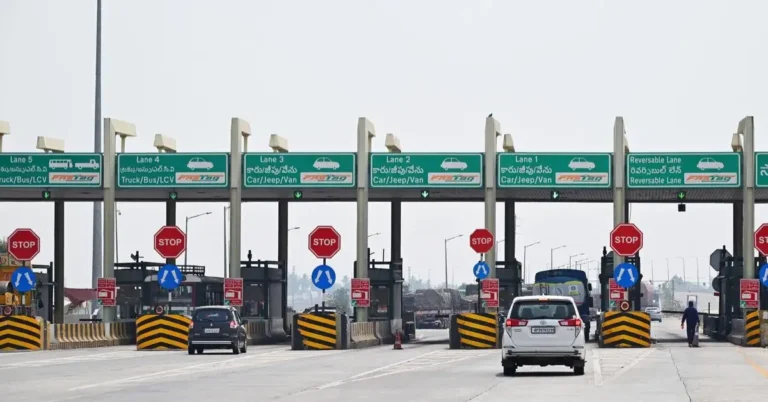 Vehicles passing through a toll plaza on a National Highway.