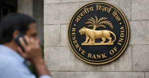 Reserve Bank of India emblem mounted on building wall with person in foreground