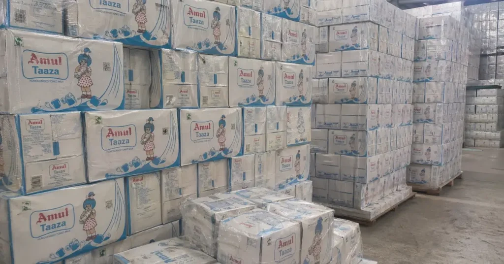 Ahmedabad Division Amul milk cartons stacked in warehouse for railway cargo transport