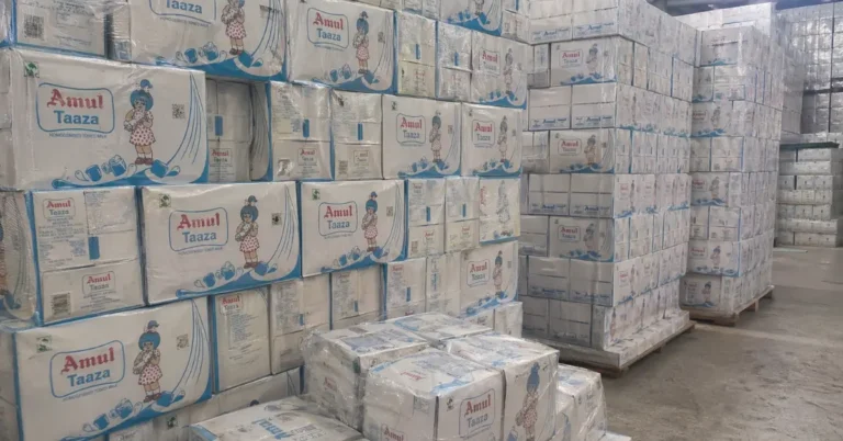 Ahmedabad Division Amul milk cartons stacked in warehouse for railway cargo transport