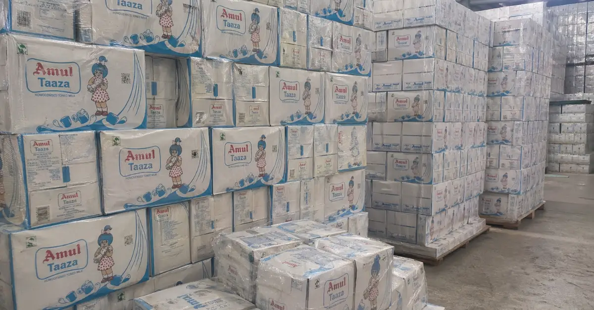 Ahmedabad Division Amul milk cartons stacked in warehouse for railway cargo transport