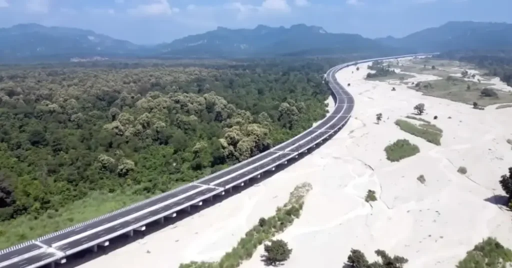 Delhi-Dehradun Expressway elevated corridor passing through forest and riverbed landscape