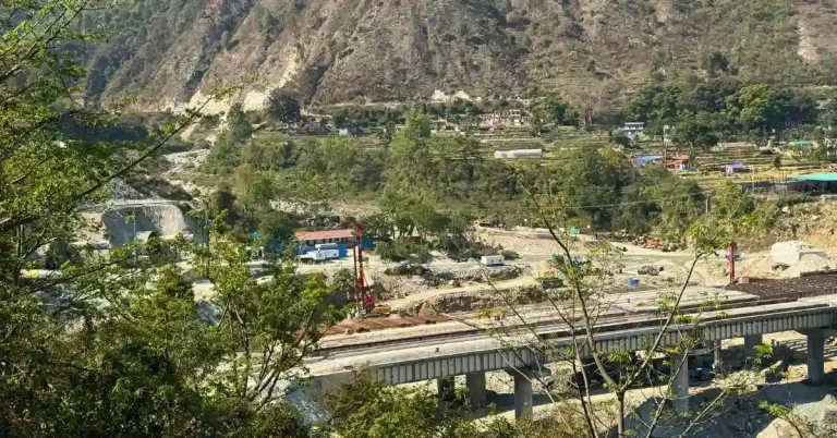 Rishikesh-Karnaprayag rail line construction site in Karnaprayag showing bridge and tunnel works in Himalayan terrain