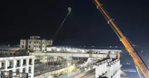 Umbergaon Road twin FOB girder launch with cranes over railway tracks