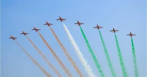 Suryakiran Aerobatic Team performs a formation flypast with tricolour smoke
