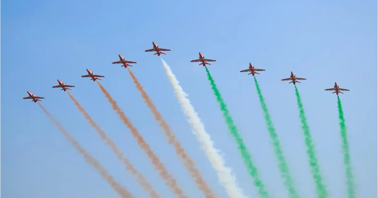 Suryakiran Aerobatic Team performs a formation flypast with tricolour smoke