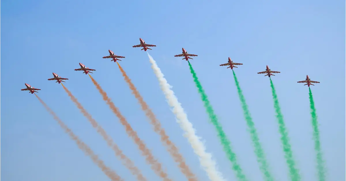 Suryakiran Aerobatic Team performs a formation flypast with tricolour smoke