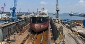 Commercial vessel undergoing repairs at Vadinar shipyard infrastructure
