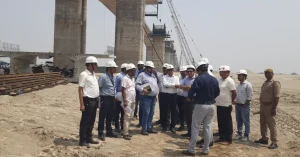Officials and technical experts inspecting a major National Highway bridge project during a site visit.