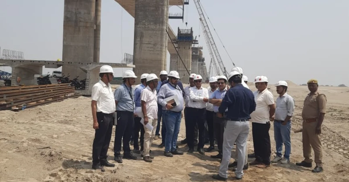 Officials and technical experts inspecting a major National Highway bridge project during a site visit.