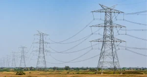 High-voltage electricity transmission towers and overhead power lines forming India's national transmission network.