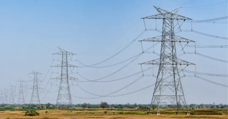High-voltage electricity transmission towers and overhead power lines forming India's national transmission network.