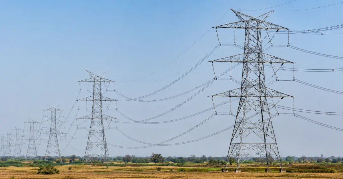 High-voltage electricity transmission towers and overhead power lines forming India's national transmission network.