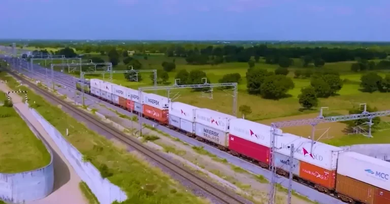 Indian Railways freight train carrying containers on an electrified rail corridor