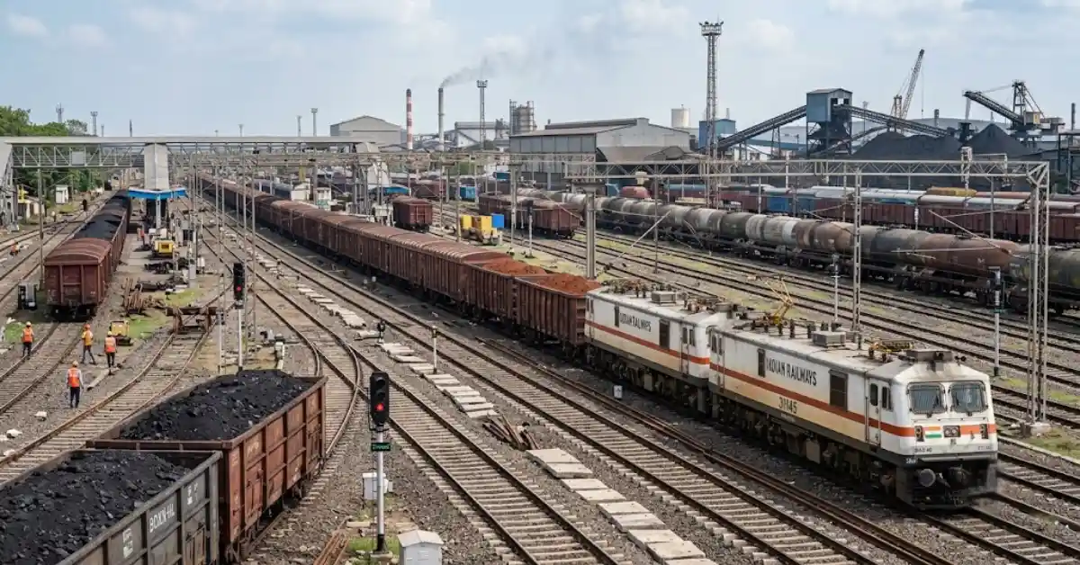 Indian Railways freight loading operations with a freight train transporting bulk commodities.