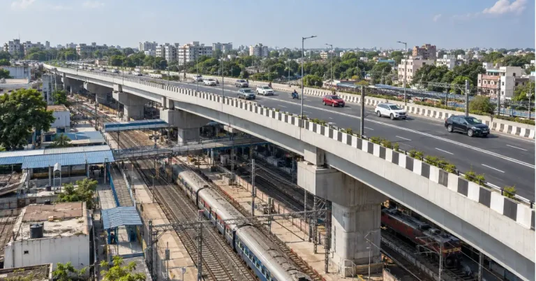 Four-lane road over bridge crossing railway tracks near an urban railway station in Vadodara