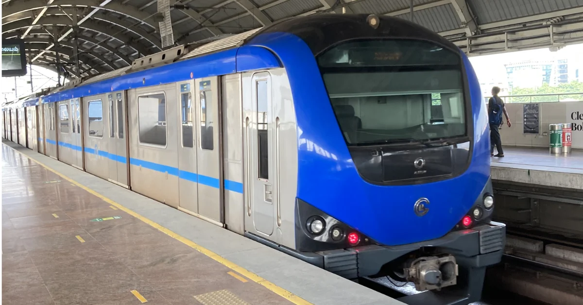 Blue Chennai Metro train standing at a covered metro station platform