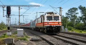 Indian Railways electric train travelling through a railway corridor with Kavach signalling infrastructure