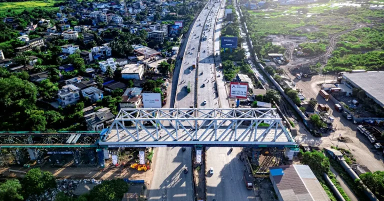 Steel bridge structure spanning a highway as part of the Mumbai-Ahmedabad Bullet Train project
