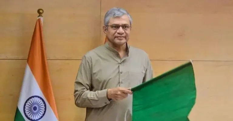 Union Railway Minister Ashwini Vaishnaw holding a green flag during the virtual flag-off of the Devendranagar–Churhat passenger train.