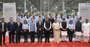 Hyundai executives, Maharashtra government representatives and plant employees pose for a group photograph inside the Talegaon automobile manufacturing facility in Pune.