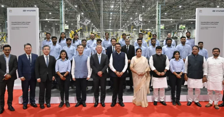 Hyundai executives, Maharashtra government representatives and plant employees pose for a group photograph inside the Talegaon automobile manufacturing facility in Pune.