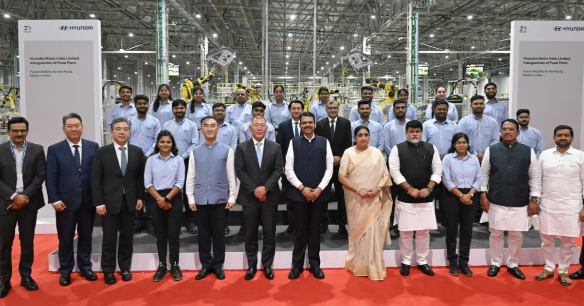 Hyundai executives, Maharashtra government representatives and plant employees pose for a group photograph inside the Talegaon automobile manufacturing facility in Pune.