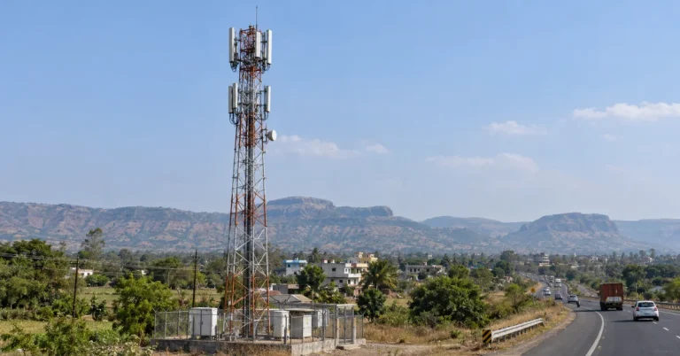 The Infra Post - India's Leading Infrastructure News Platform 29 Documentary-style view of a telecom tower beside a Nashik-region highway, providing context for BSNL's plan for 211 new towers.