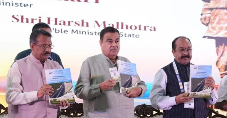Union Minister Nitin Gadkari and officials displaying NHAI's Wildlife Mitigation Measures & Structures publication on wildlife-sensitive highway planning.