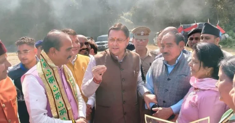 Uttarakhand Chief Minister Pushkar Singh Dhami interacts with residents and officials during his visit to Champawat, accompanied by local representatives.